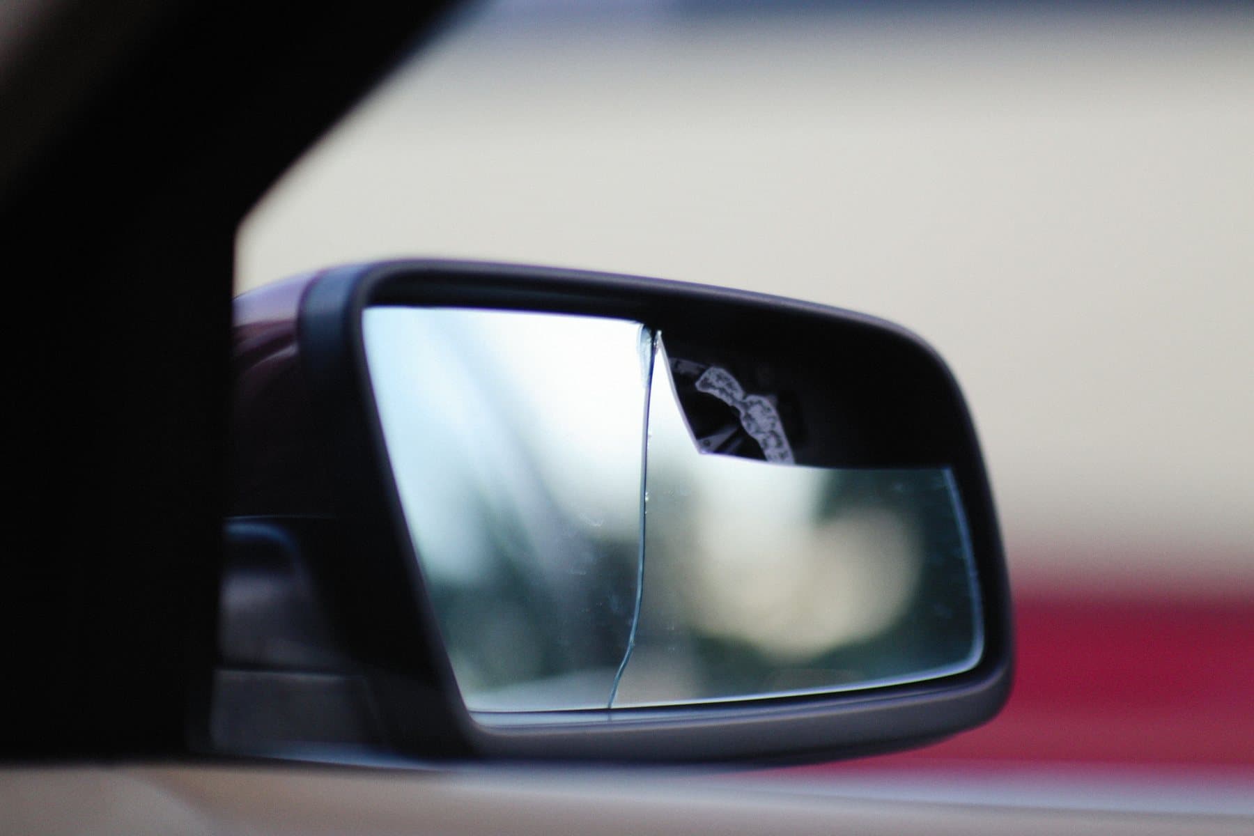 Cracked vehicle side mirror glass