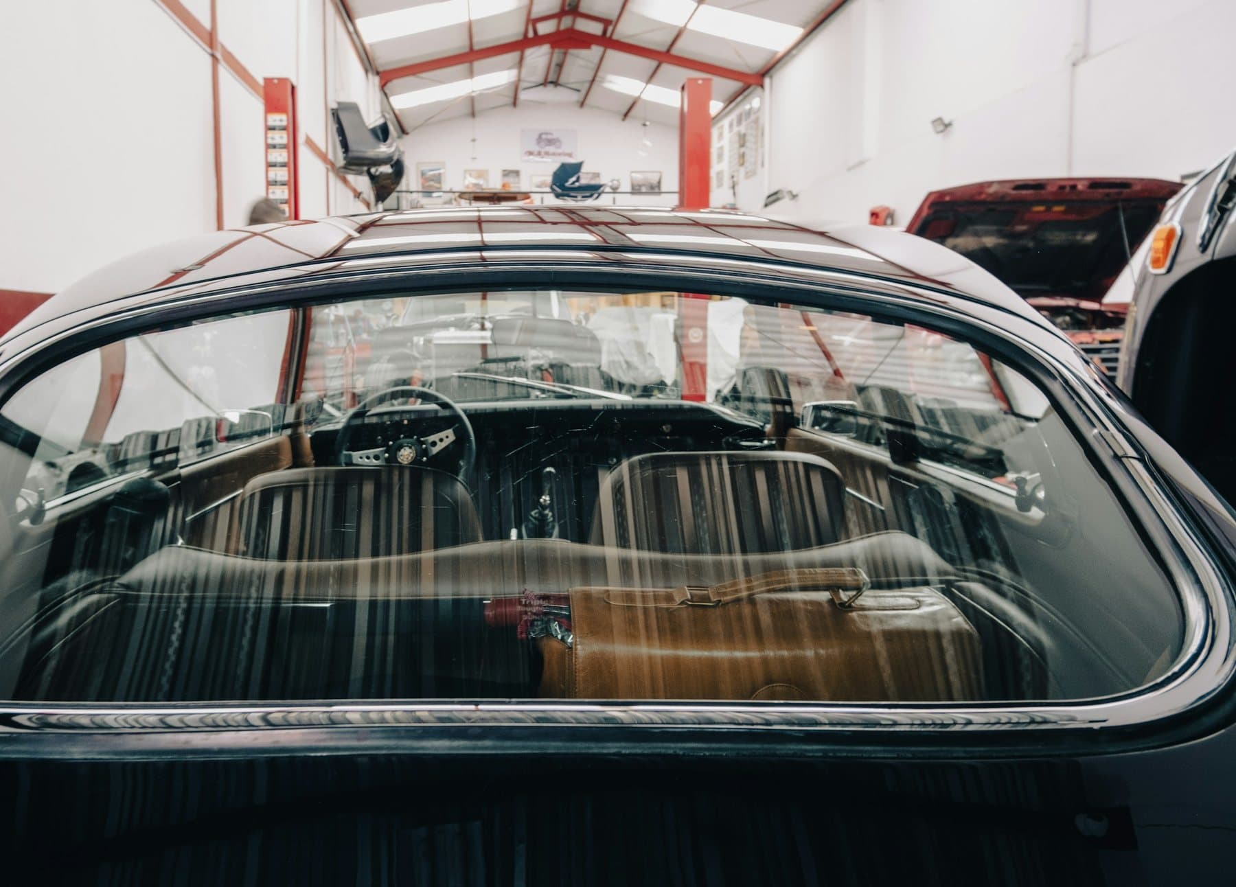 Vehicle glass viewed inside a clean automotive shop