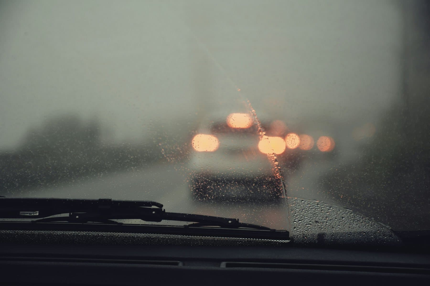 Rain-covered windshield viewed from inside a vehicle